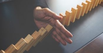 problem-solving-close-up-view-hand-business-woman-stopping-falling-blocks-table-concept-about-taking-responsibility_1418-55
