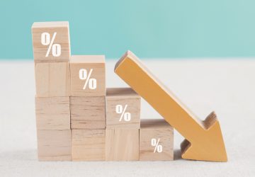 wooden-blocks-with-percentage-sign-down-arrow-financial-recession-crisis-interest-rate-decline-investment-reduce-concept