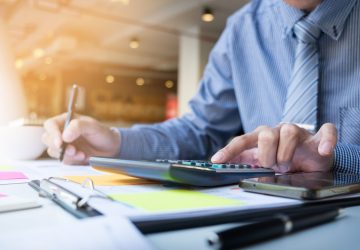 Business finance man calculating budget numbers, Invoices and financial adviser working.