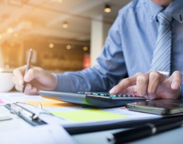 Business finance man calculating budget numbers, Invoices and financial adviser working.