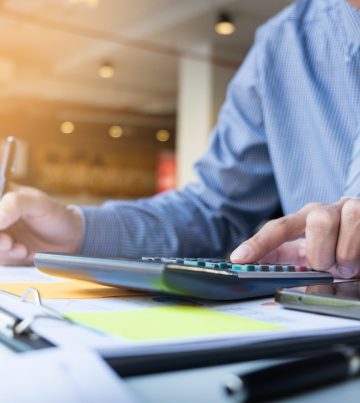 Business finance man calculating budget numbers, Invoices and financial adviser working.