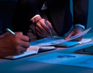Close-up image of business partners working with financial documents