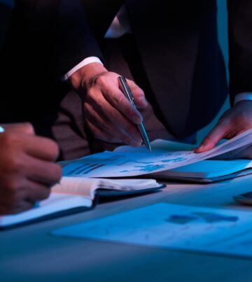 Close-up image of business partners working with financial documents